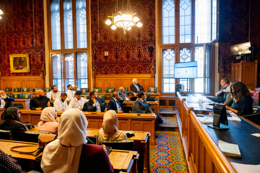 Attendees watch the screening of the documentary Human Tide during the APPG on Hajj & Umrah meeting at the Palace of Westminster.